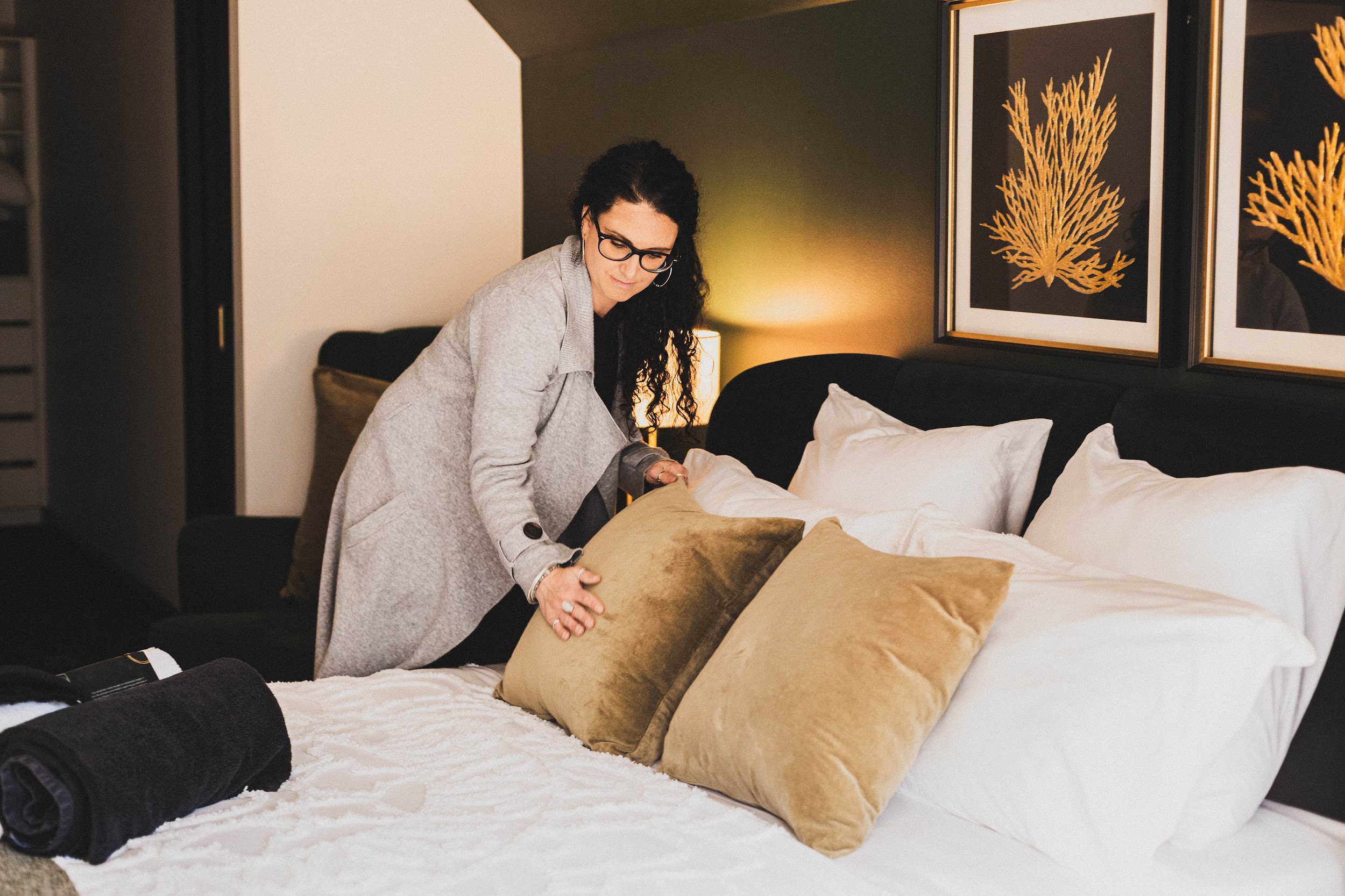 woman sit next to bed